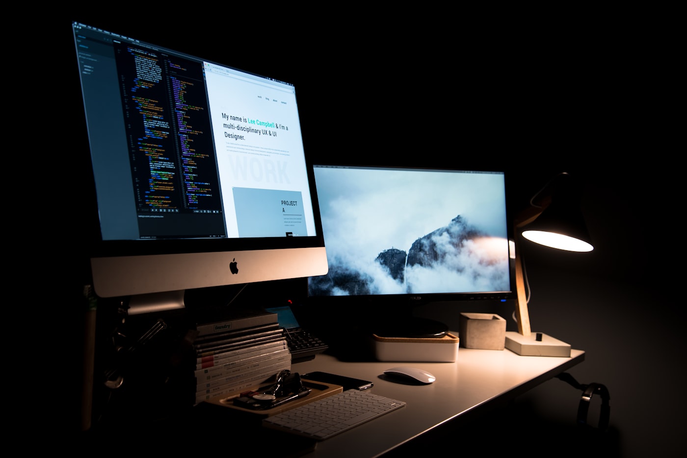 Design studio desk at night with a website open on screen